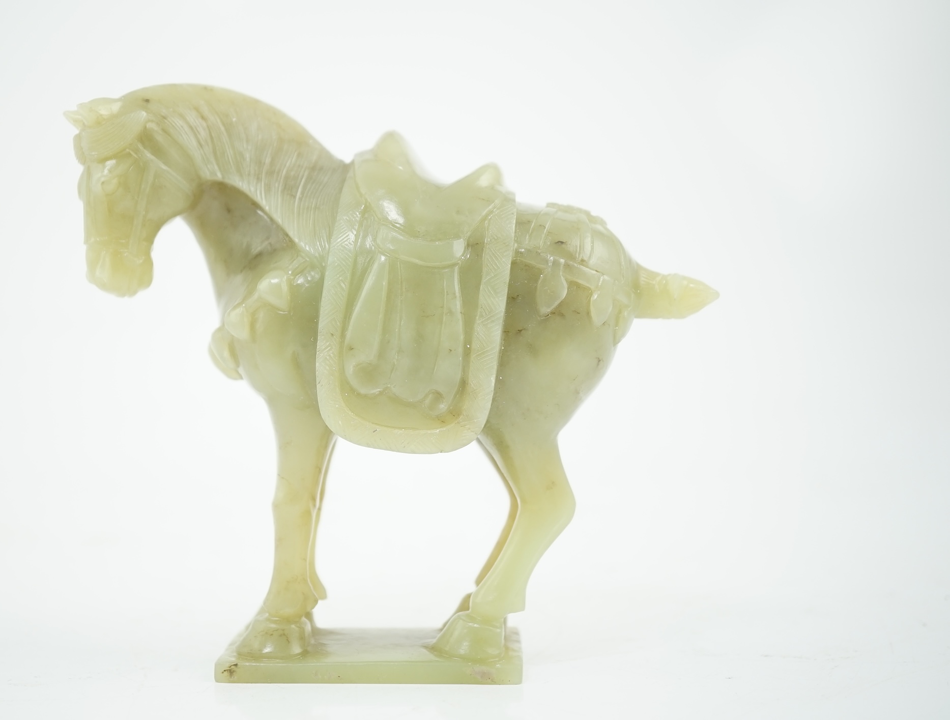 A Chinese celadon jade figure of a horse, early 20th century, 12cm high